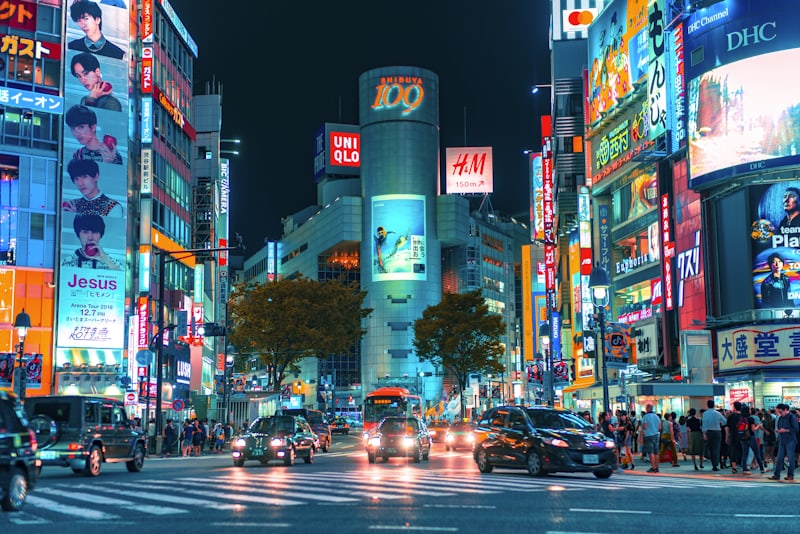 A night photo of Shibuya, Tokyo — neon signs reflected on a wet street